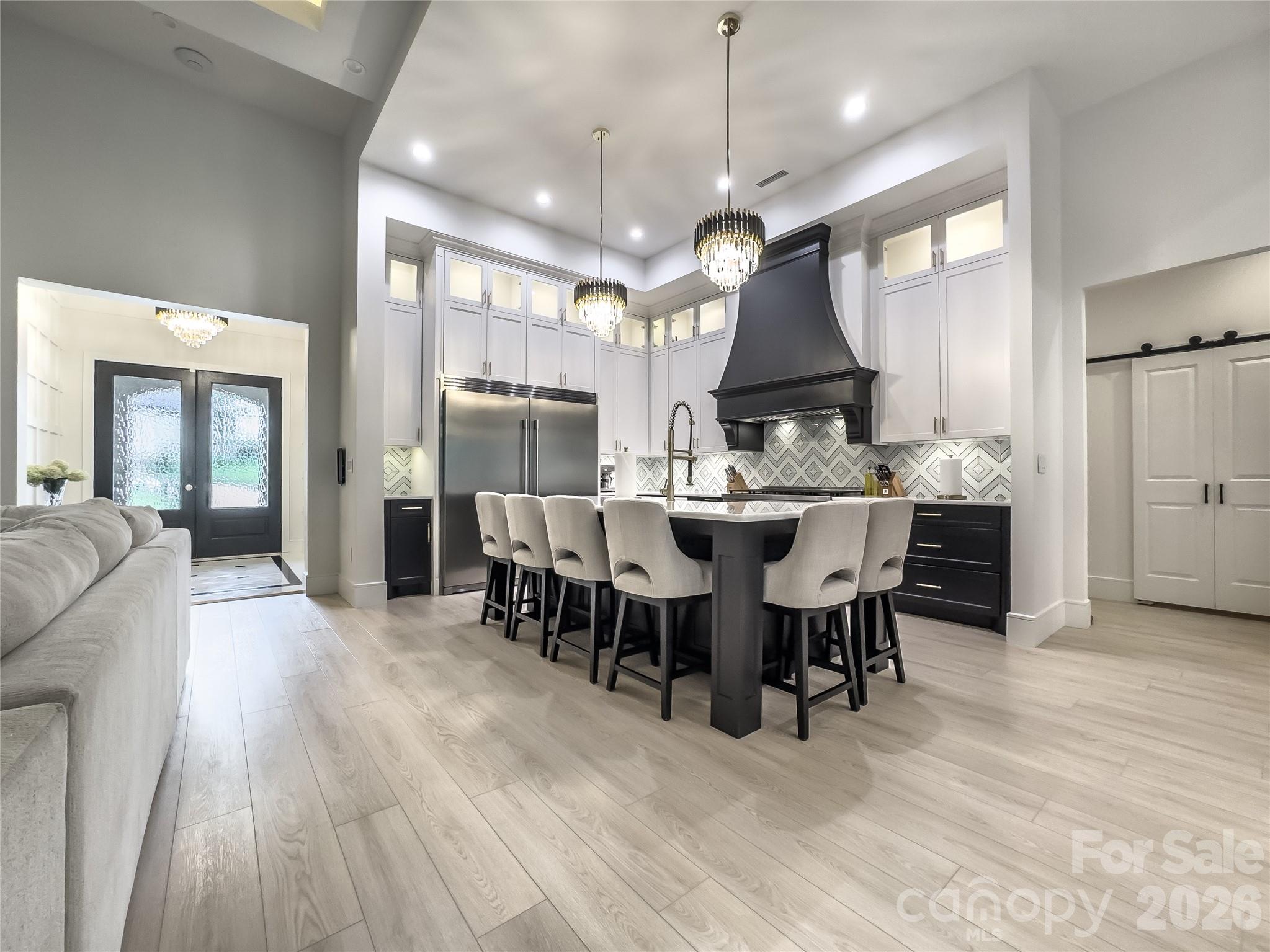 668 Players Ridge Road Hickory, NC 28601 - Photo 4 of 48 a view of a a dining room and livingroom with furniture wooden floor a chandelier