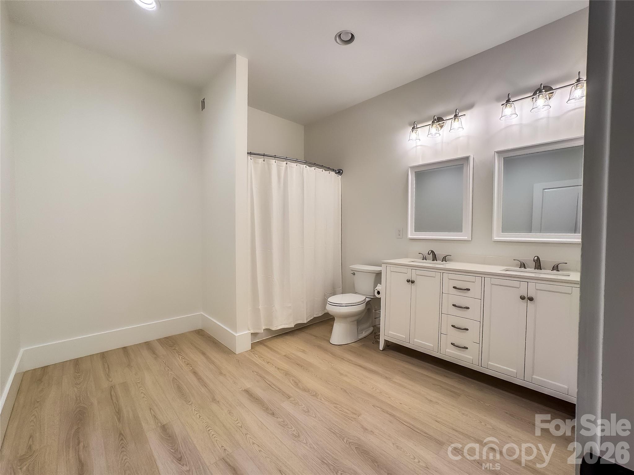 668 Players Ridge Road Hickory, NC 28601 - Photo 41 of 48 a spacious bathroom with a double vanity sink a mirror and a toilet