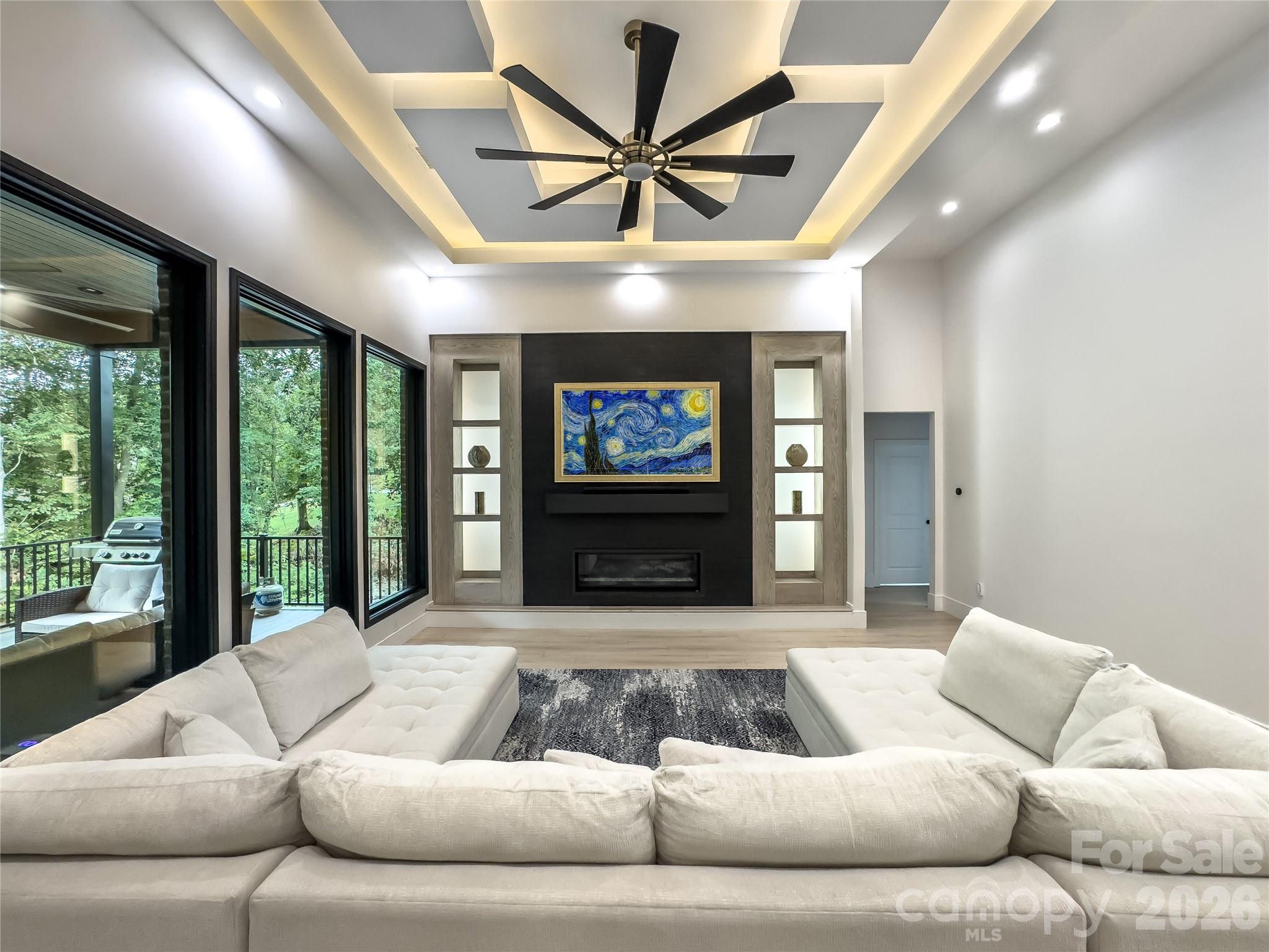 668 Players Ridge Road Hickory, NC 28601 - Photo 6 of 48 a living room with furniture ceiling fan and a large window