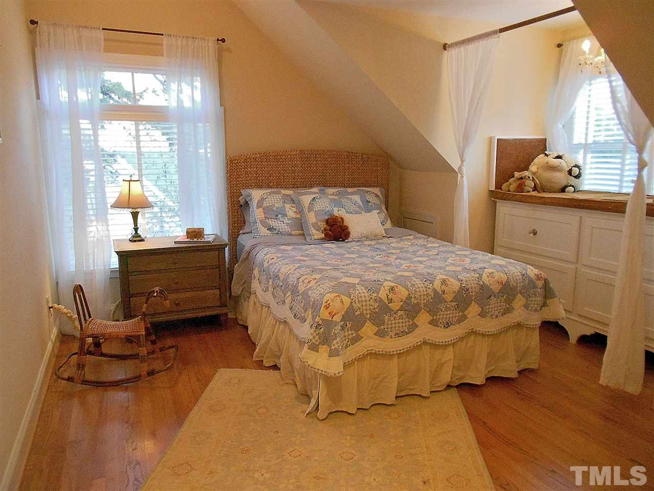 309 Forsyth Street Raleigh, NC 27609 - Photo 22 of 25 a bedroom with a bed and window