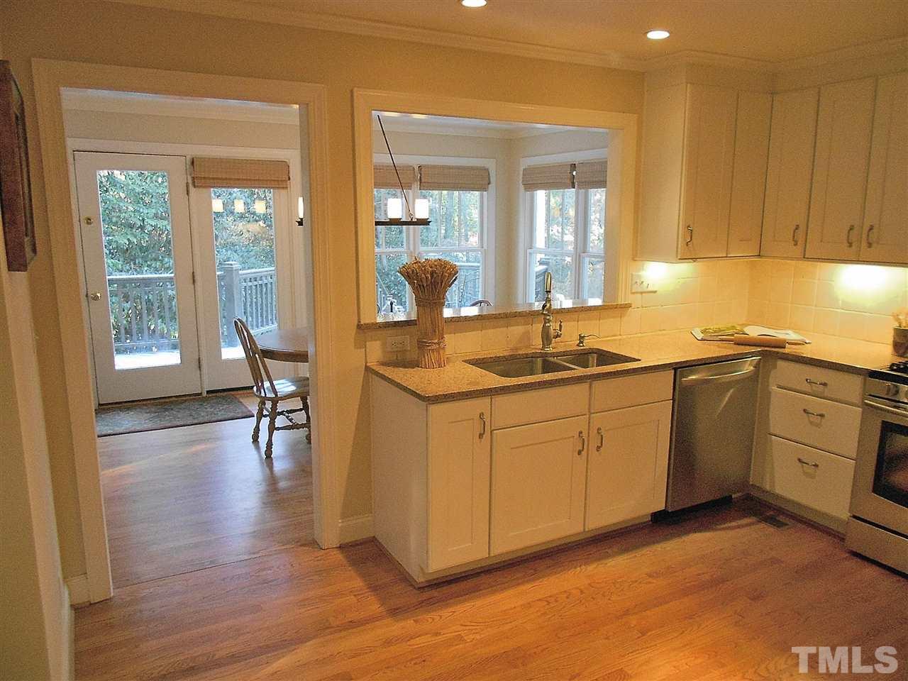 309 Forsyth Street Raleigh, NC 27609 - Photo 8 of 25 a kitchen with sink cabinets and wooden floor