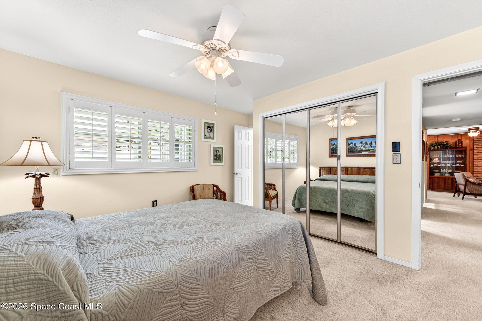935 Samar Road Cocoa Beach, FL 32931 - Photo 12 of 22 a bedroom with a large bed and a chandelier