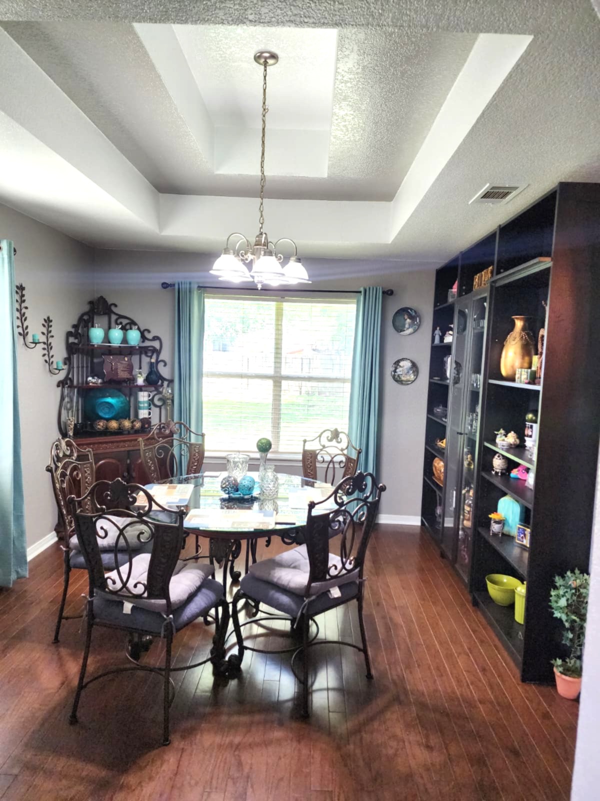 5603 Hunters Ridge Trail Killeen, TX 76542 - Photo 5 of 13 Rich hardwood floors complement tray ceilings and a classic chandelier, defining this inviting dining space.