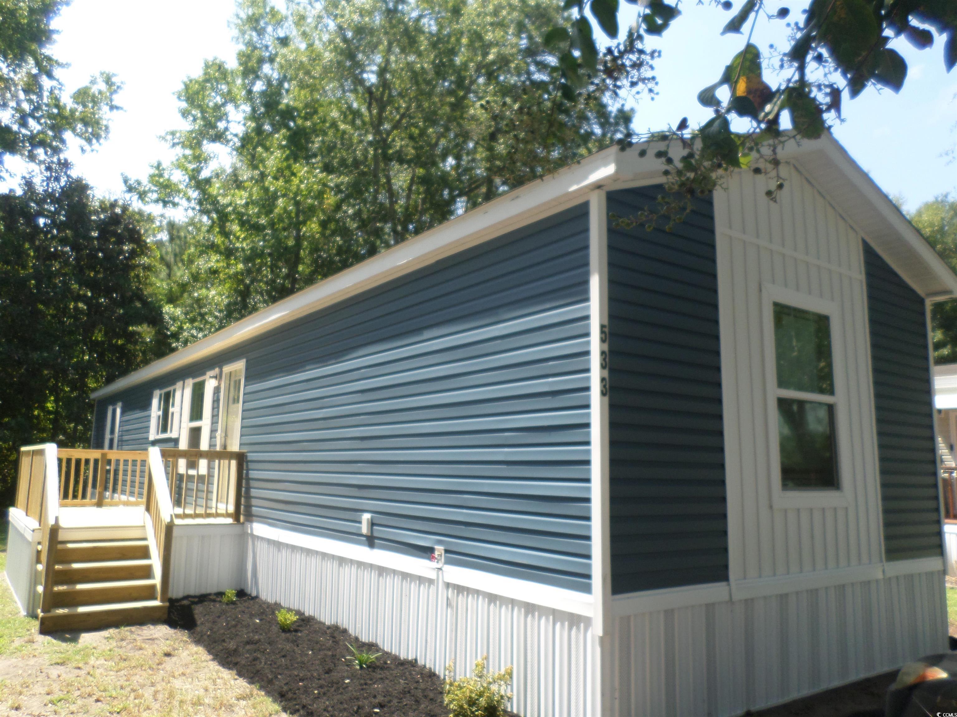 533 Key Largo Avenue Murrells Inlet, SC 29576 - Photo 1 of 21 View of side of home featuring a wooden deck