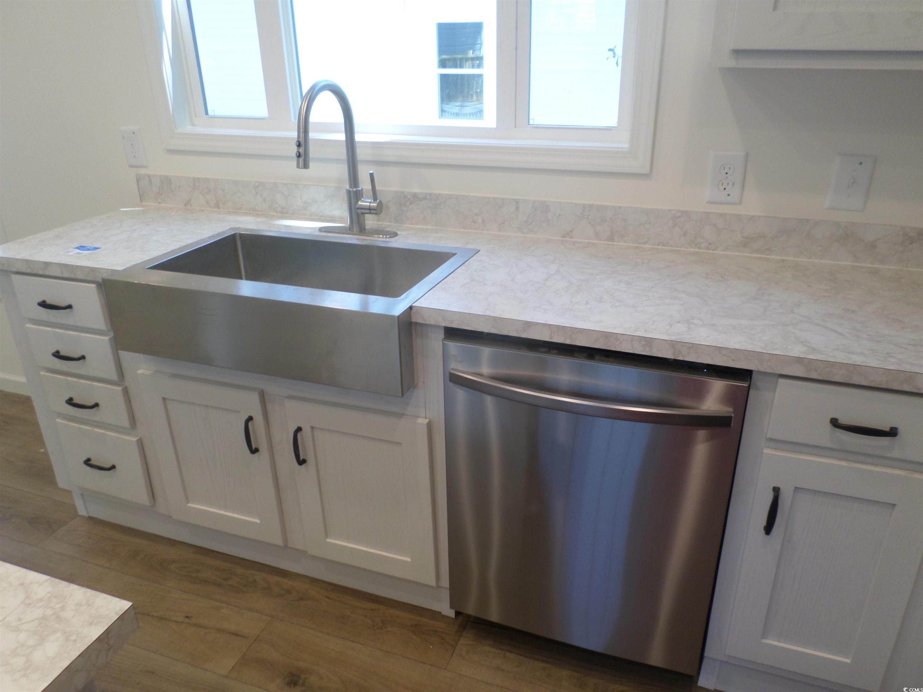 533 Key Largo Avenue Murrells Inlet, SC 29576 - Photo 11 of 21 Kitchen with stainless steel dishwasher, light countertops, and plenty of natural light