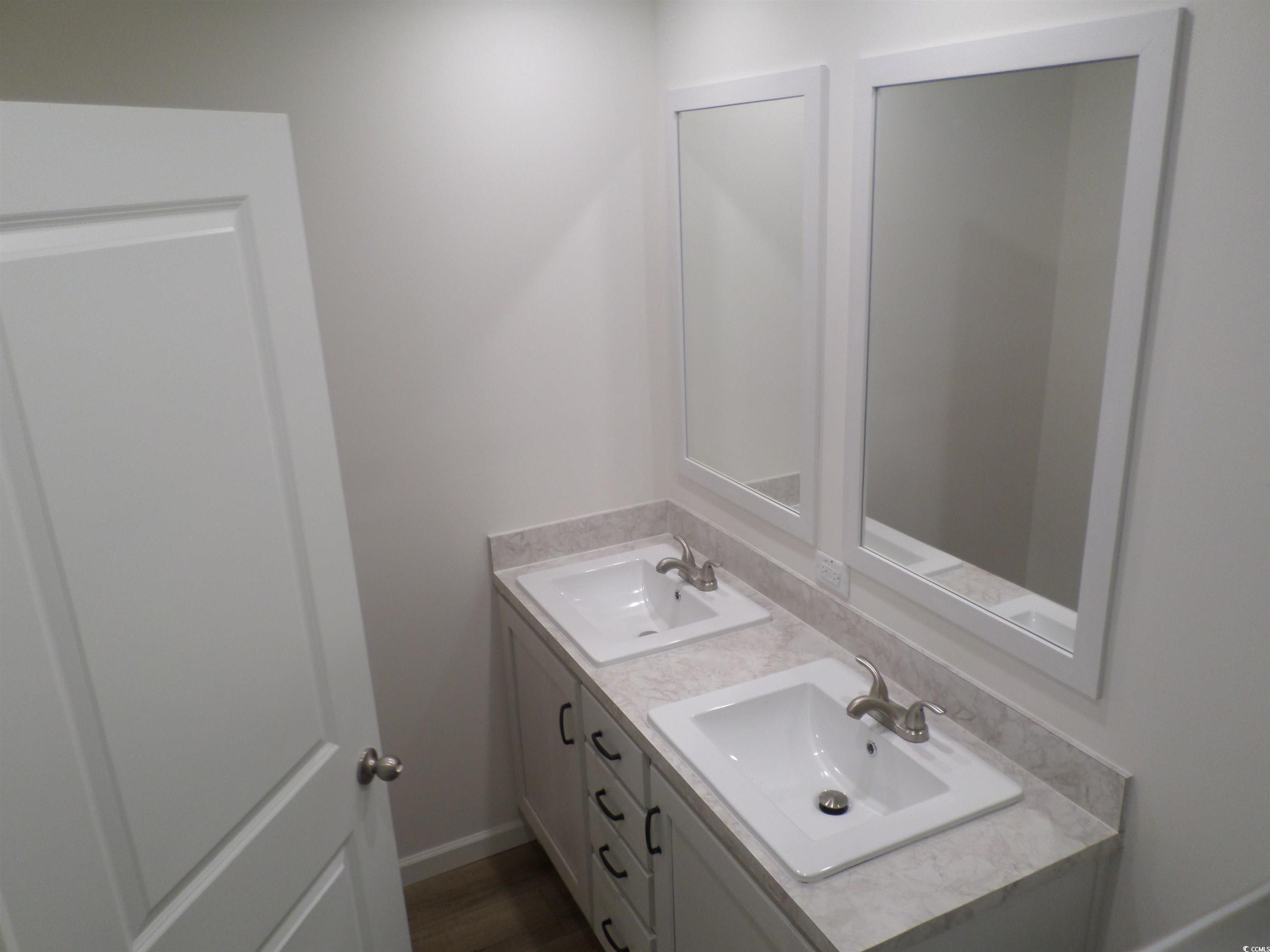 533 Key Largo Avenue Murrells Inlet, SC 29576 - Photo 13 of 21 Bathroom with double vanity and baseboards