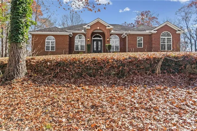 a front view of a house with a garden