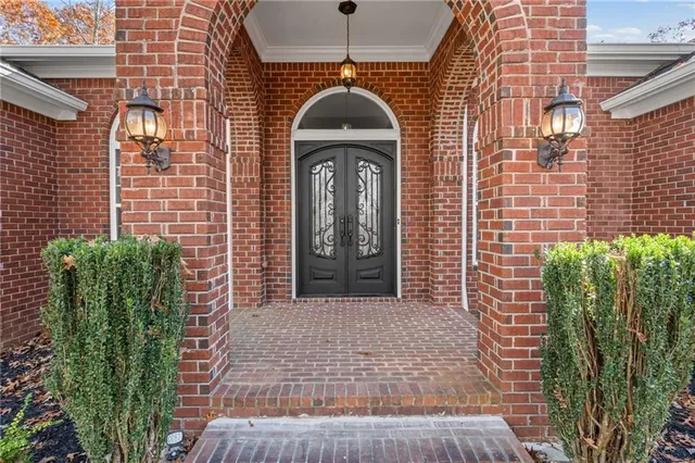 a front view of a house with a garden