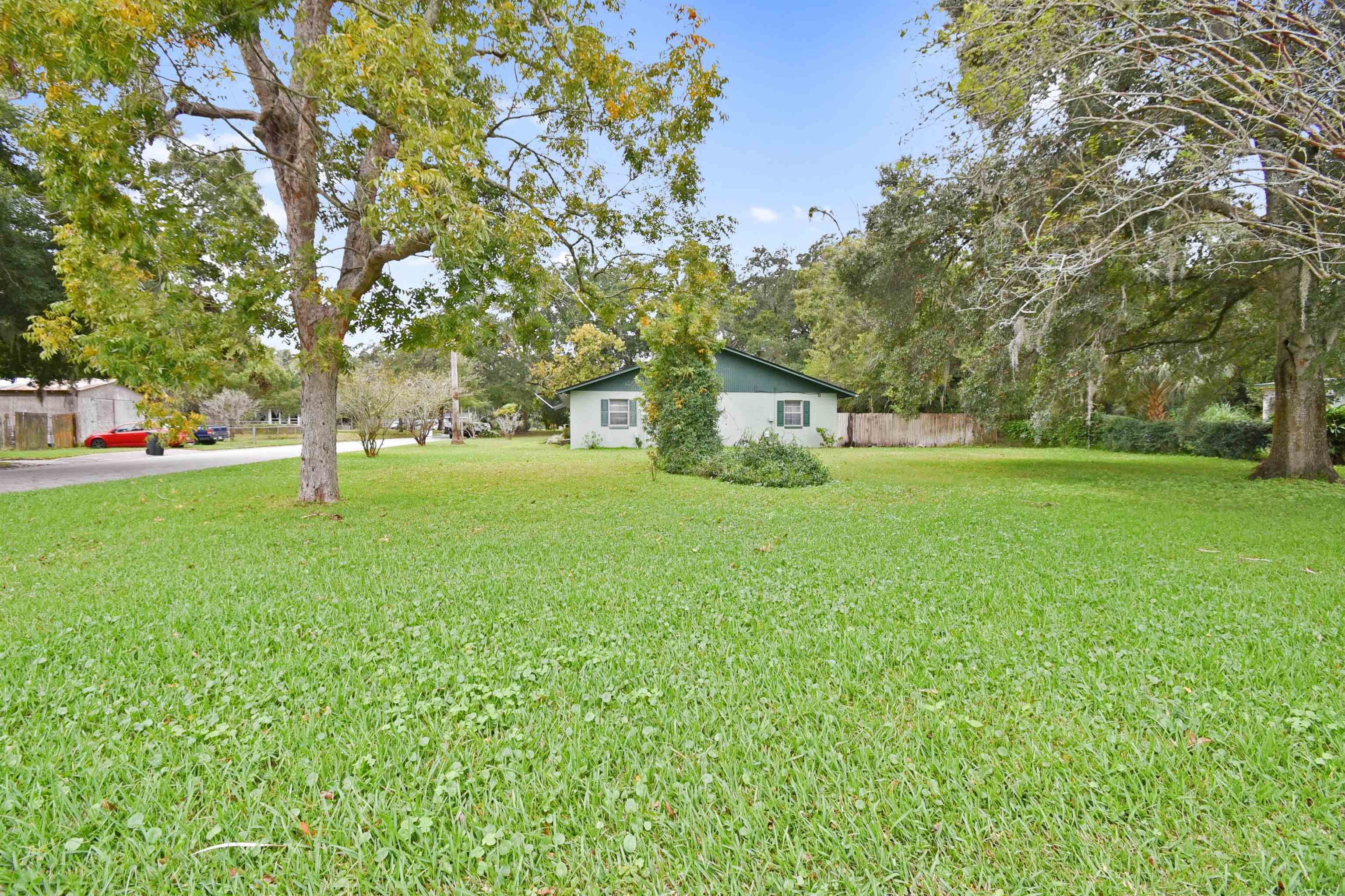 200 Theodore Street St. Augustine, FL 32084 - Photo 20 of 22 a backyard of a house with lots of green space and fountain