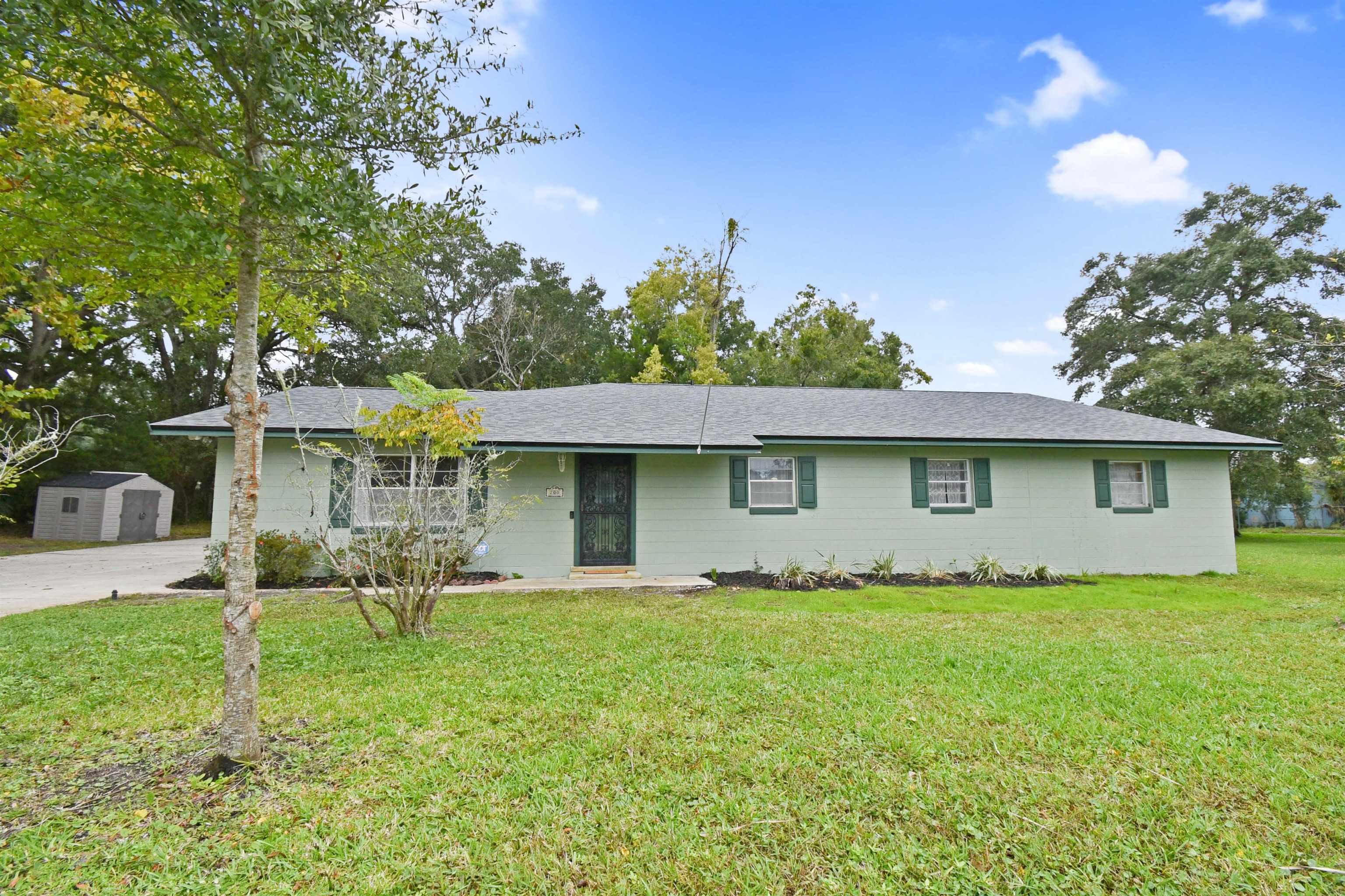 200 Theodore Street St. Augustine, FL 32084 - Photo 2 of 22 a backyard of a house with table and chairs