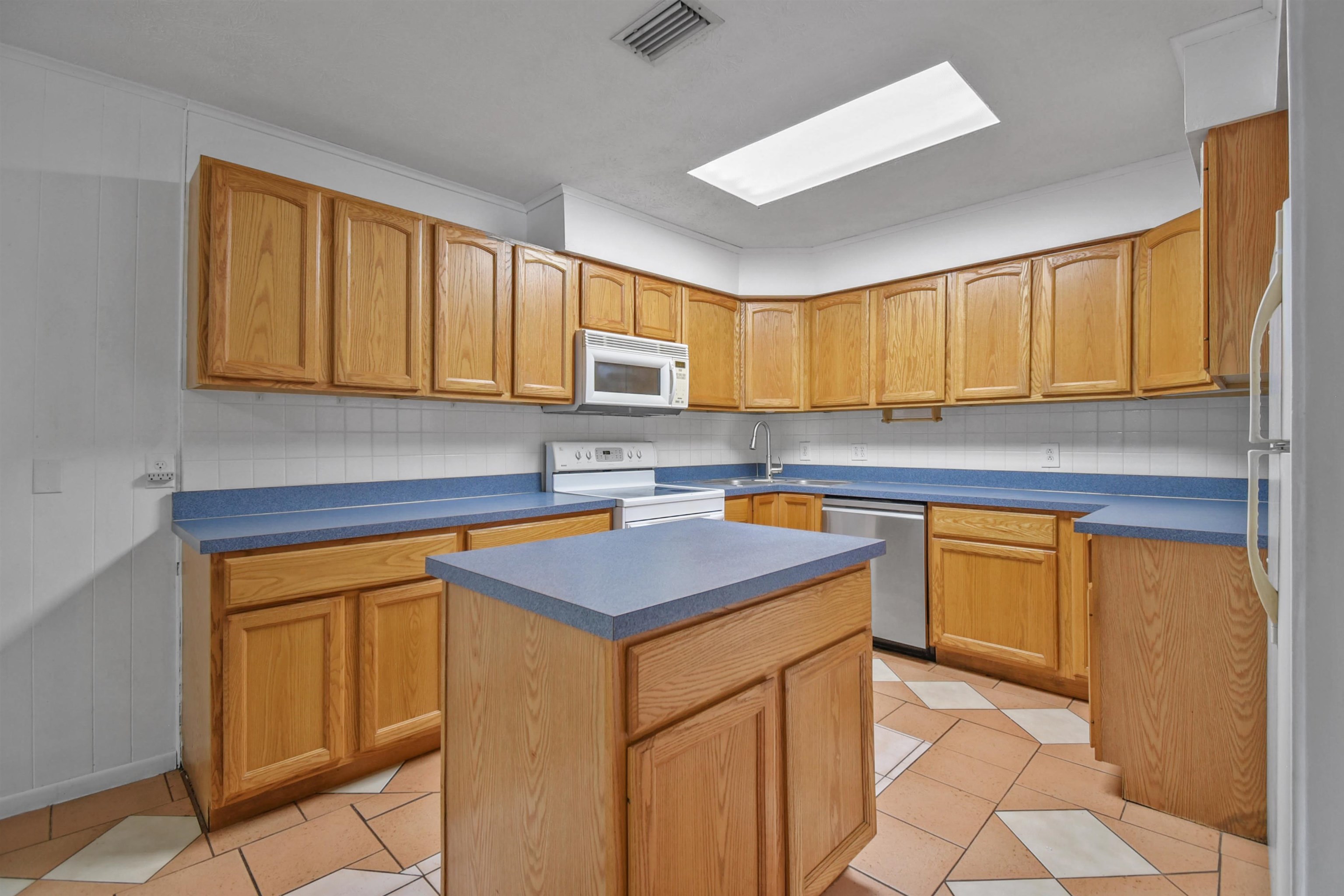 200 Theodore Street St. Augustine, FL 32084 - Photo 4 of 22 a kitchen with stainless steel appliances granite countertop a sink stove and cabinets