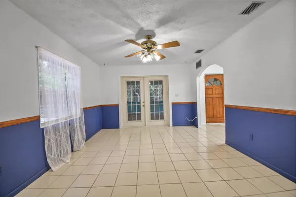 a view of an empty room with a chandelier