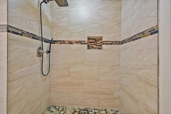 a view of empty room with a ceiling fan and window