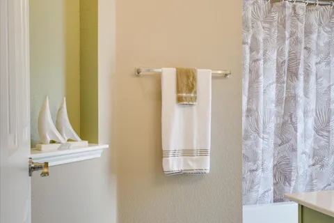 a view of a bathroom with a sink and a mirror