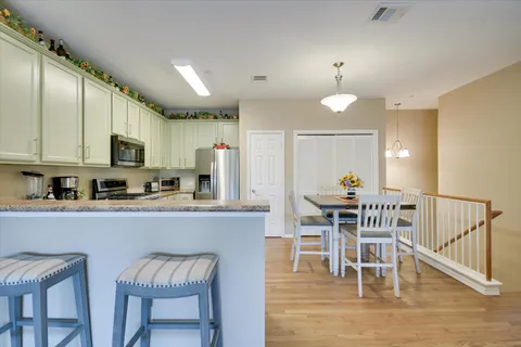 a view of kitchen with cabinets table and chairs