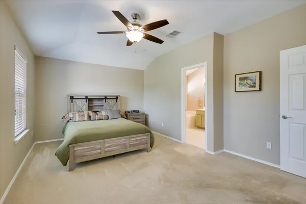 a bedroom with a bed and a ceiling fan