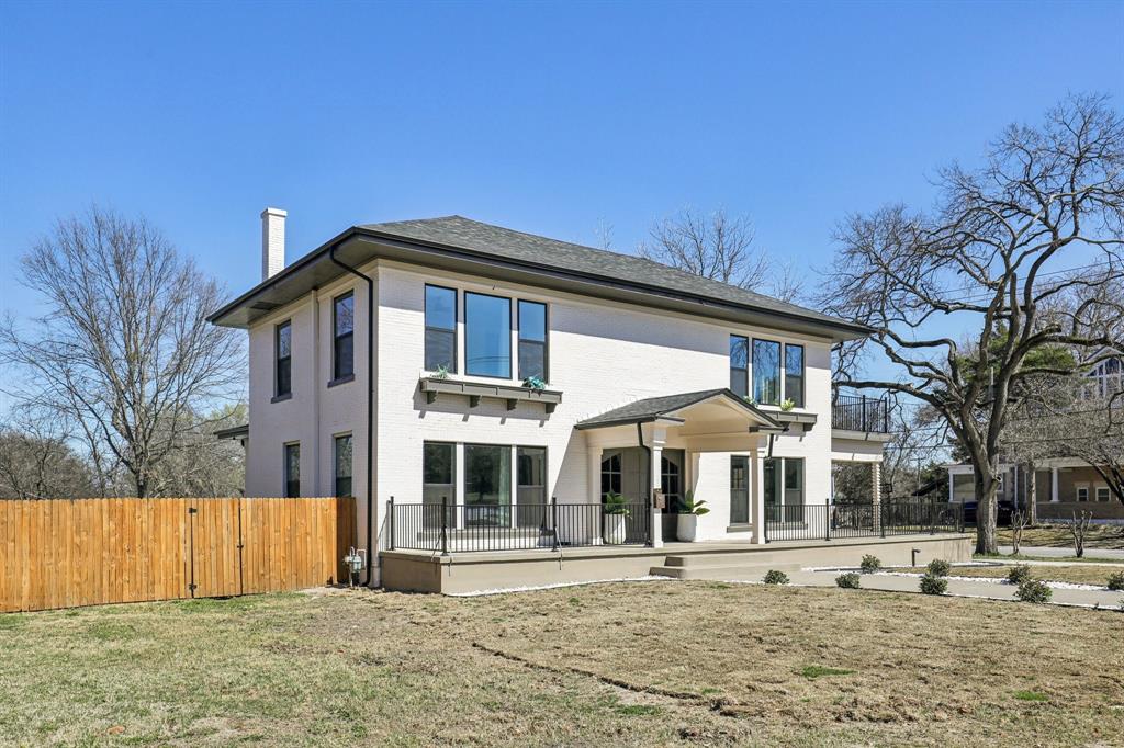 702 Griffith Avenue Terrell, TX 75160 - Photo 4 of 40 Rear view of house featuring a chimney, brick siding, and a patio