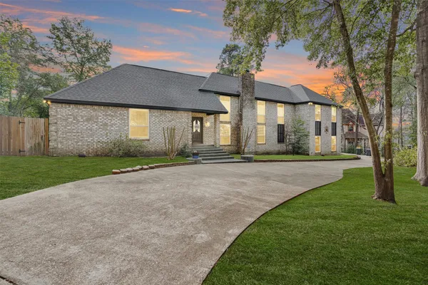 a front view of house with yard and green space