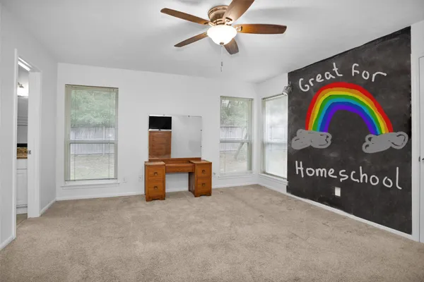 a view of an entryway and a hall with a fan