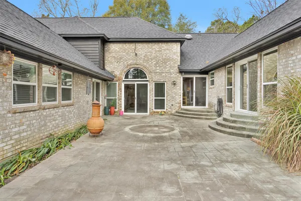 a front view of a house with a yard and seating space