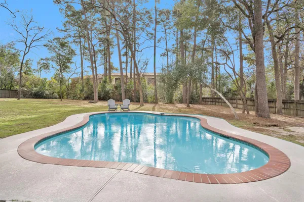 a view of swimming pool with outdoor seating