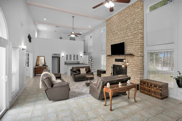 a living room with furniture a fireplace and a flat screen tv