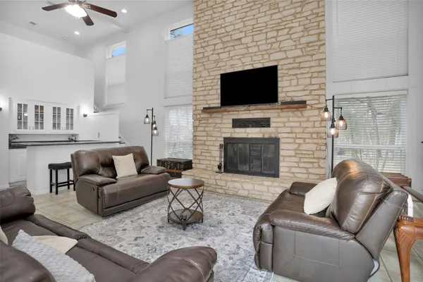 a living room with furniture a fireplace and a flat screen tv