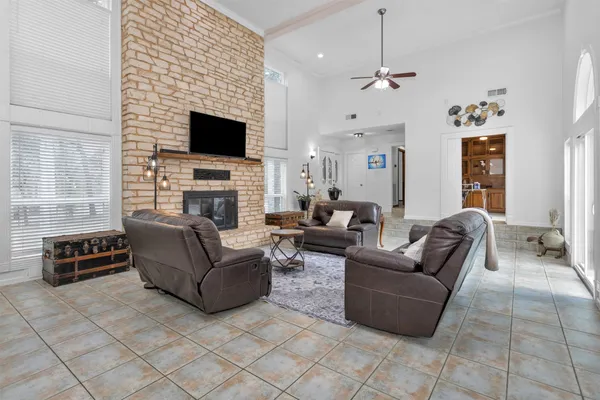 a living room with furniture a flat screen tv and a fireplace