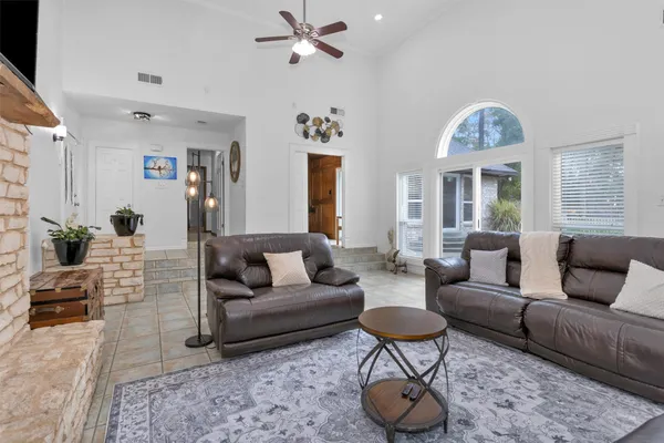 a living room with furniture potted plant and a chandelier