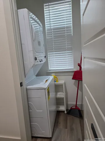 a bathroom with a granite countertop toilet and a sink