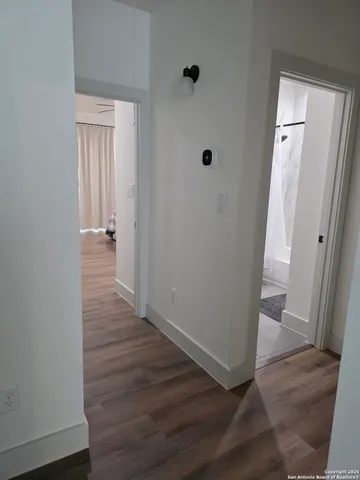 a bedroom with a bed wooden floor and a ceiling fan