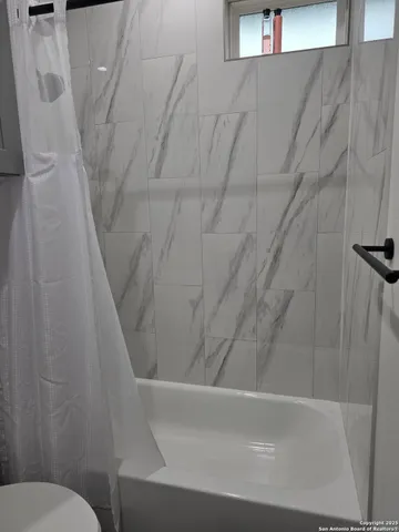 a bedroom with a bed and large window