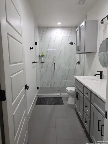 a bathroom with a sink vanity and mirror