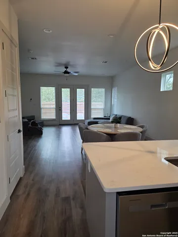a kitchen with a table chairs and wooden floor