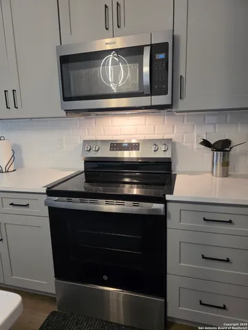 a kitchen with a sink and wooden cabinets