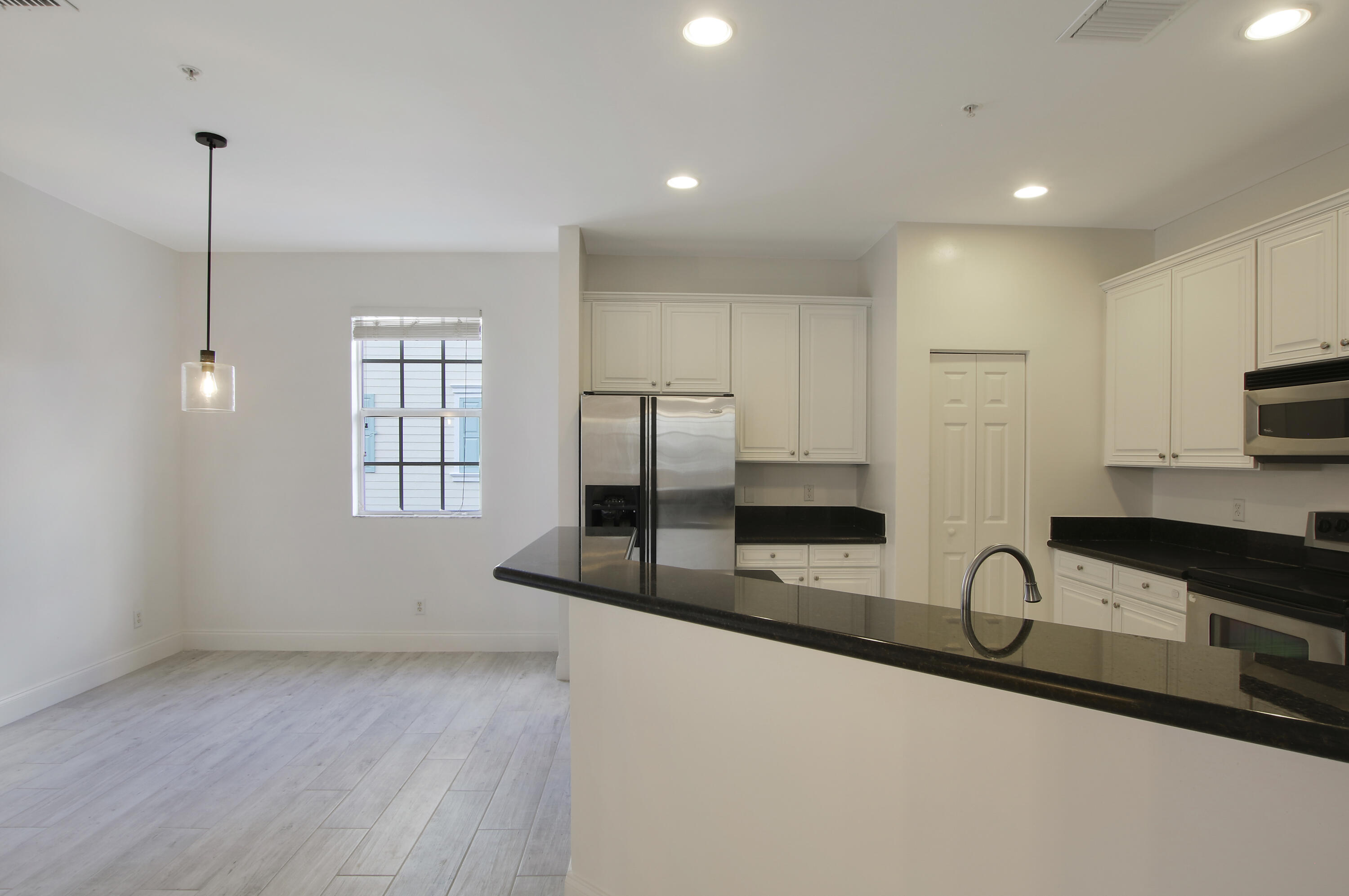 108 Locustberry Lane, Unit 105 Jupiter, FL 33458 - Photo 5 of 36 Kitchen with Dining Room