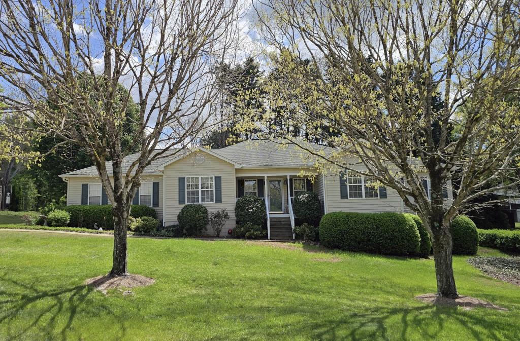 a front view of house with yard and green space