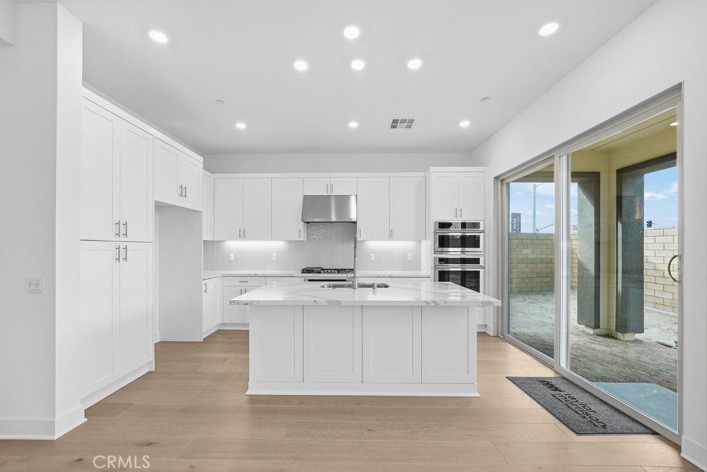 118 Pansy Irvine, CA 92618 - Photo 2 of 46 a large kitchen with stainless steel appliances lots of counter space and a sink