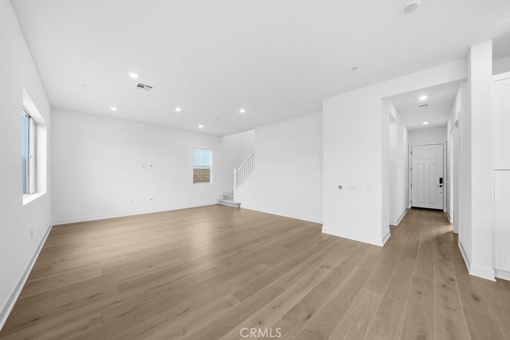 118 Pansy Irvine, CA 92618 - Photo 8 of 46 an empty room with wooden floor and windows