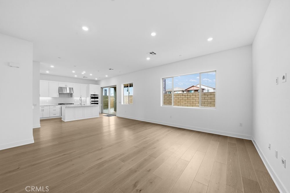 118 Pansy Irvine, CA 92618 - Photo 9 of 46 a view of an empty room with wooden floor and a window