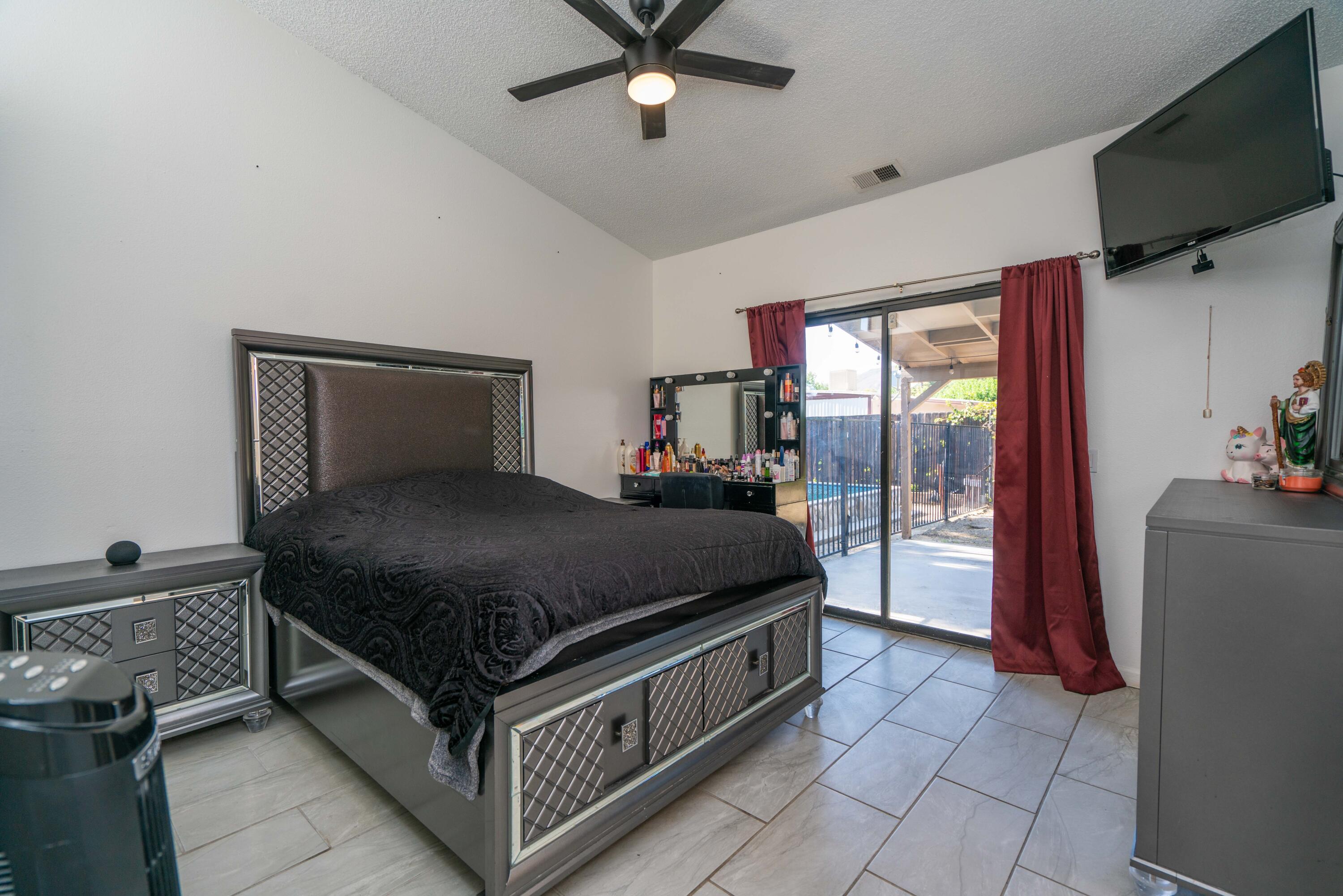419 Quandt Ranch Road San Jacinto, CA 92583 - Photo 18 of 40 a bed room with a bed and a television