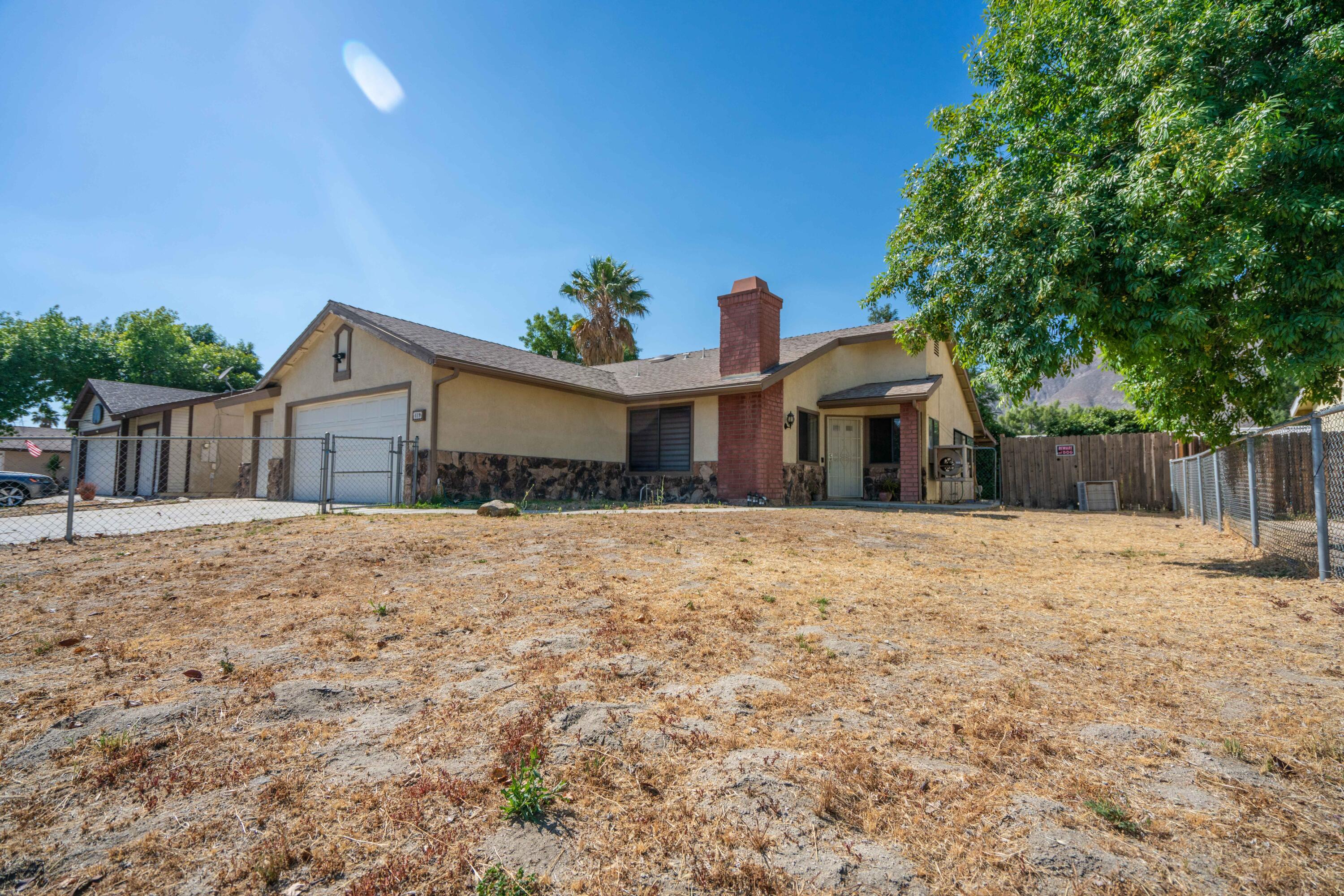 419 Quandt Ranch Road San Jacinto, CA 92583 - Photo 5 of 40 a front view of a house with a yard and garage