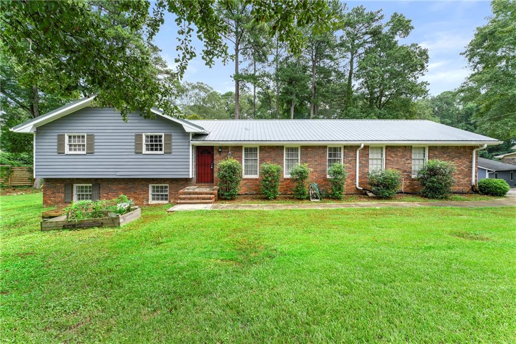a front view of house with yard and green space