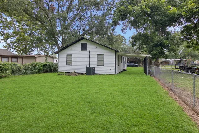 a view of backyard of house with green space