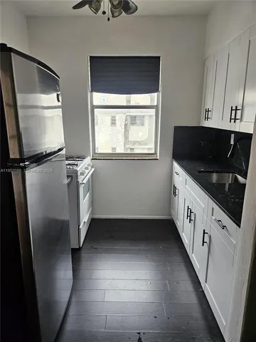 a kitchen with stainless steel appliances a refrigerator sink and microwave