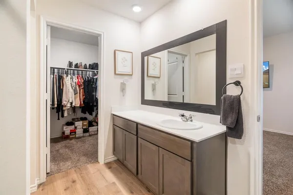 a bathroom with a sink vanity and mirror