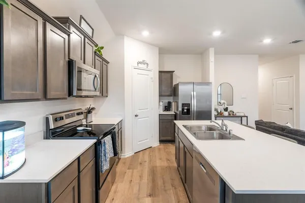 a kitchen with a sink stove and refrigerator