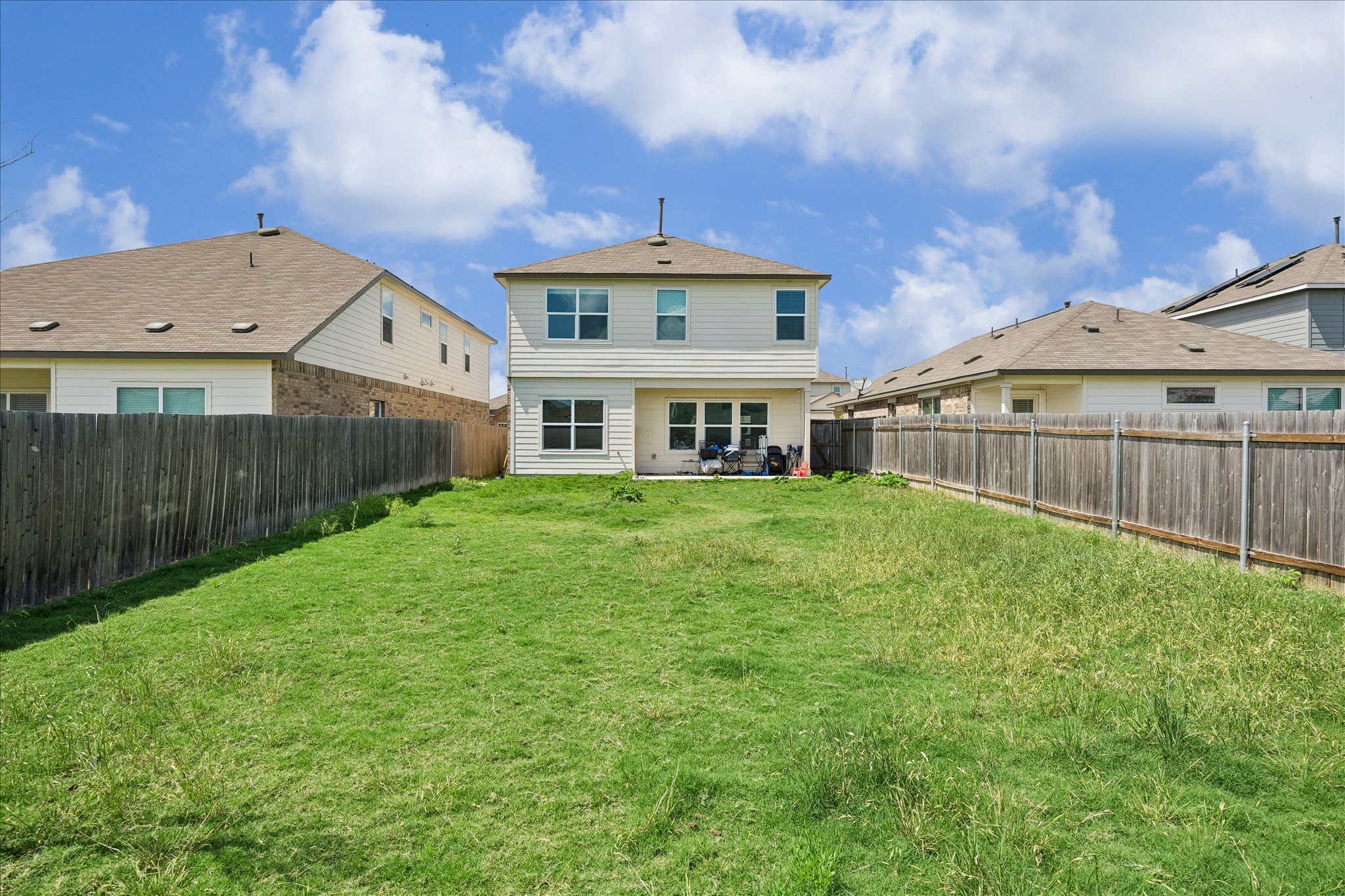 217 Canley Loop Hutto, TX 78634 - Photo 34 of 36 A spacious backyard awaits, fully fenced for privacy and outdoor enjoyment.