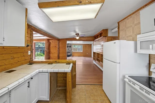 a kitchen with granite countertop a sink stainless steel appliances and cabinets
