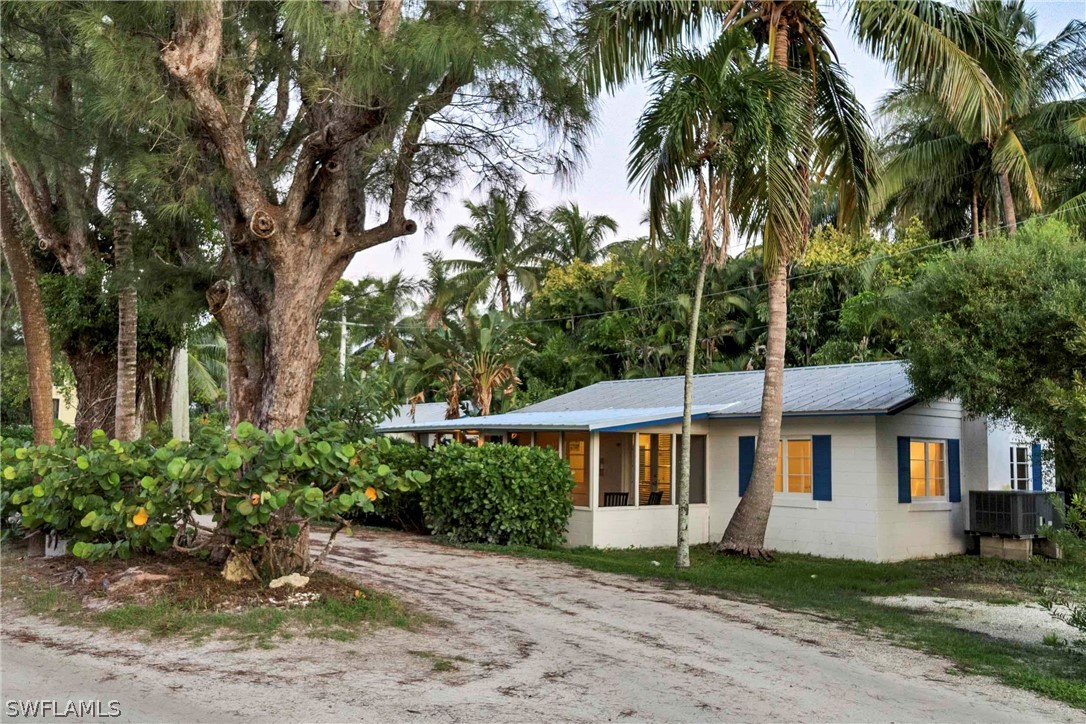 15107 Captiva Drive Captiva, FL 33924 - Photo 12 of 35 a front view of a house with a garden